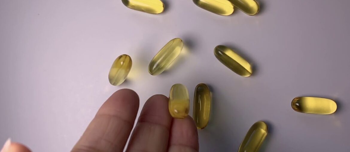 Dropping Gold Fish Oil Capsules Vitamin Supplements FromHand Slow Motion - Free Stock Footage